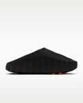 Black sandal with orange sole on a white background