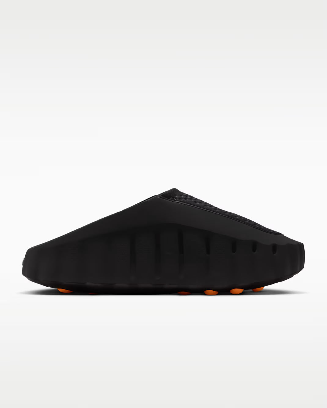 Black sandal with orange sole on a white background