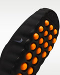 Black massage roller with orange nodes featuring a Nike logo on a white background