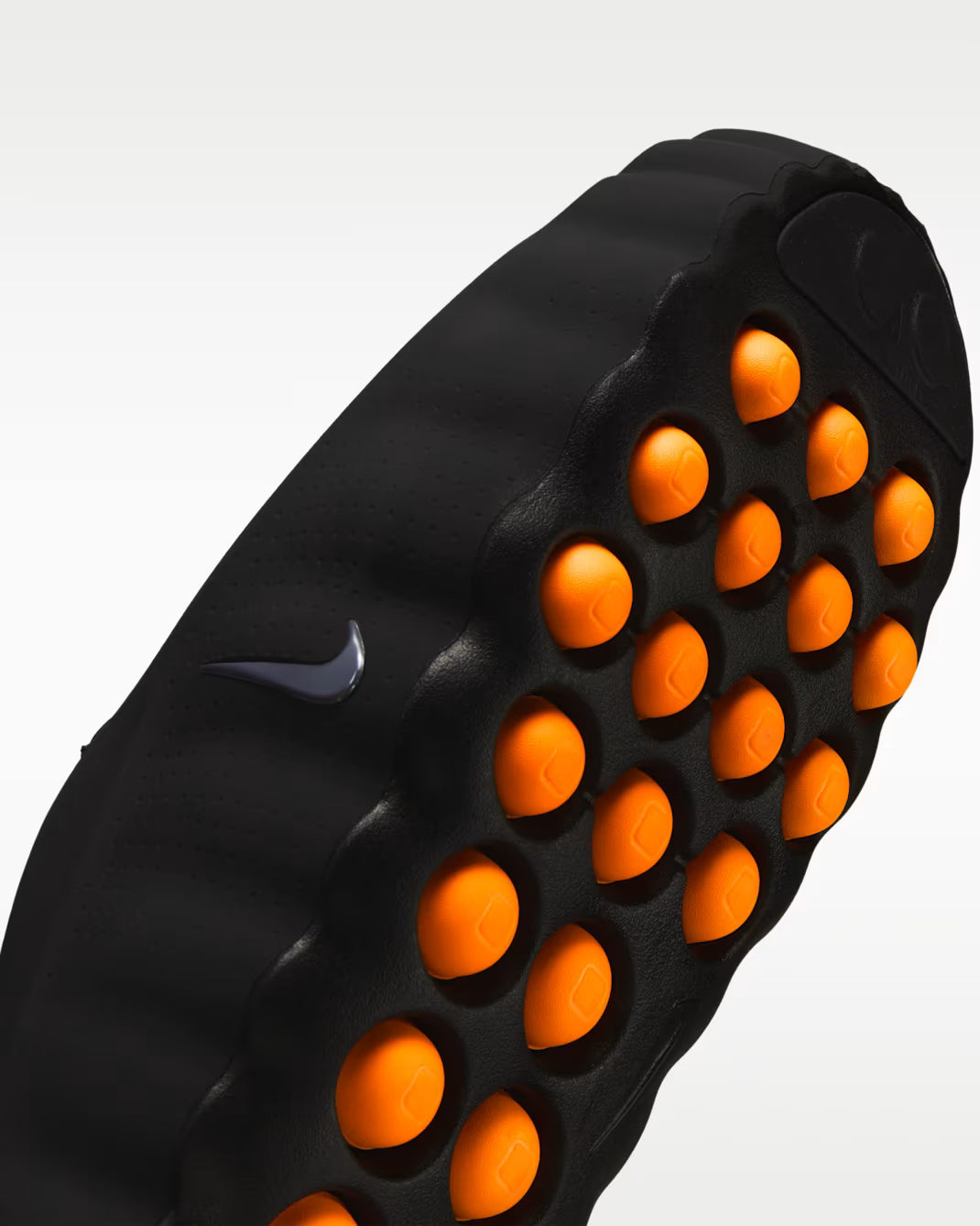Black massage roller with orange nodes featuring a Nike logo on a white background