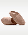 A pair of Nike slip-on clogs in a dusty rose pink color, displayed against a clean white background.