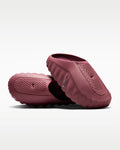 Pair of maroon slippers on a light gray background