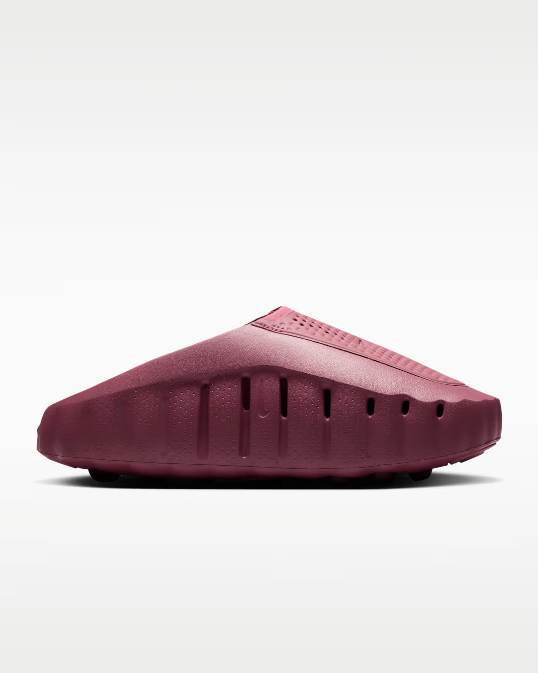 Pair of maroon slippers on a light gray background