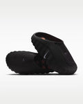 Black sandals with a Nike logo on a white background