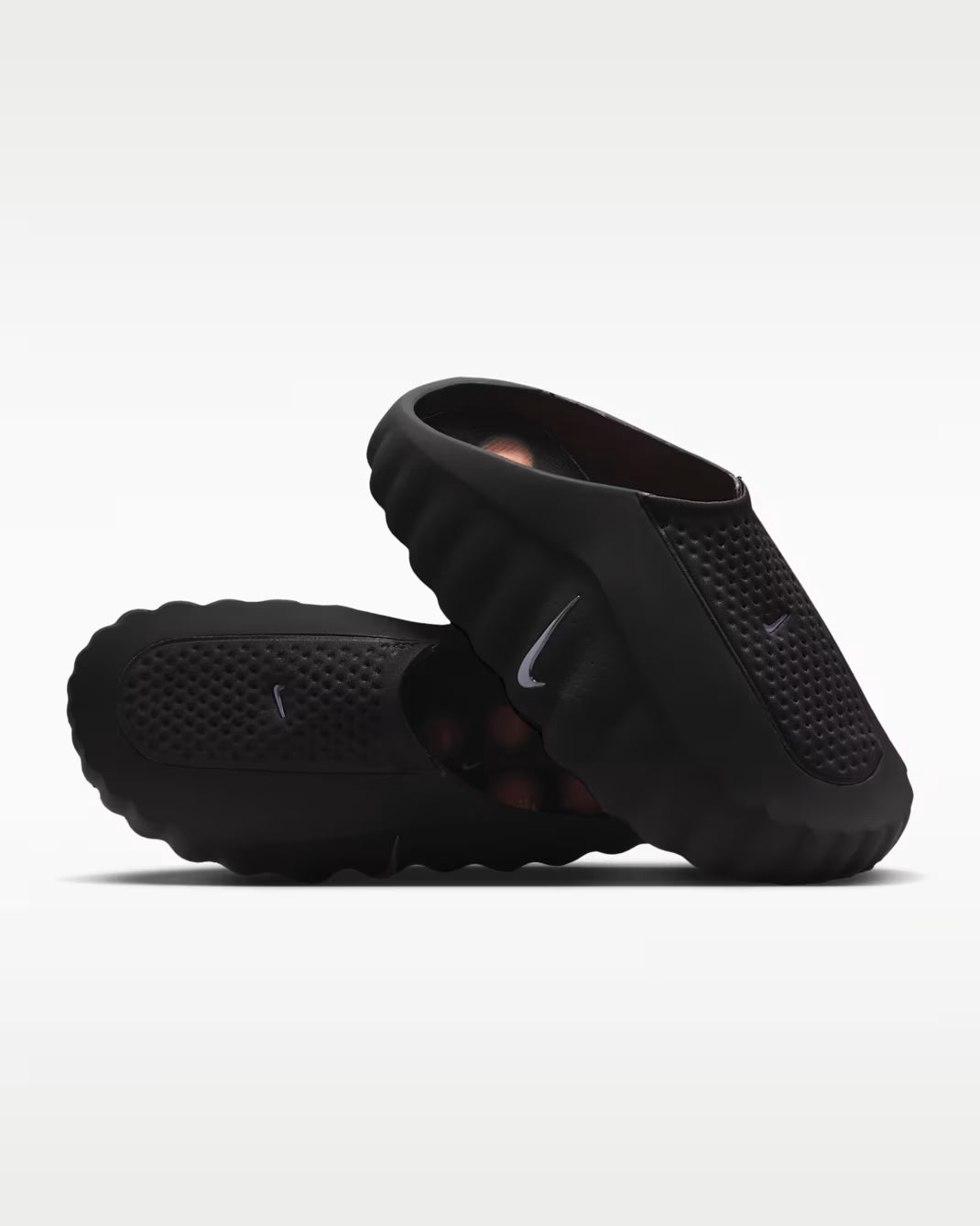 Black sandals with a Nike logo on a white background